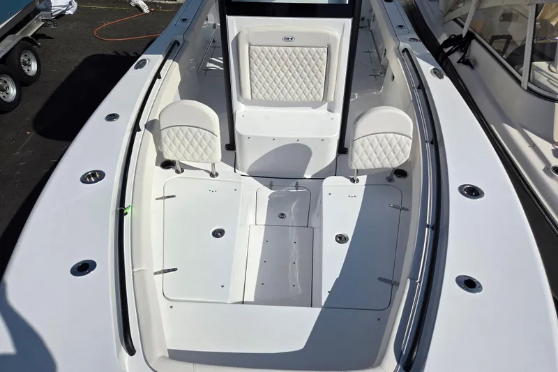 Slide: The Image of 2026 Sea Hunt Gamefish 25 boat interior with white seating and deck layout. - 13