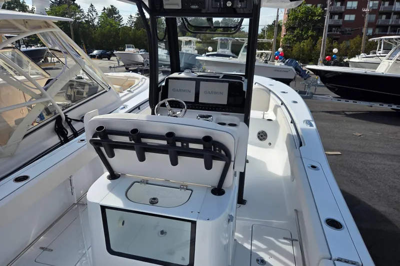 Slide: The Image of 2026 Sea Hunt Gamefish 25 boat interior with Garmin electronics, rod holders, and spacious deck. - 5