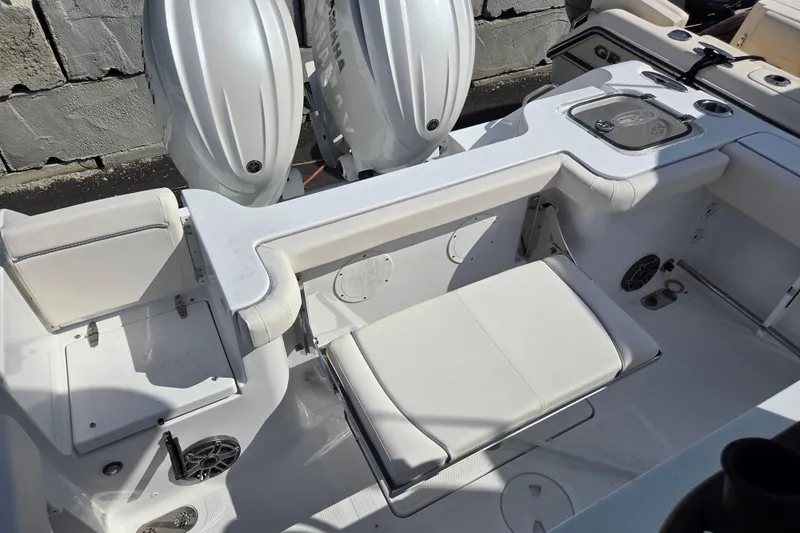 Slide: The Image of 2026 Sea Hunt Gamefish 25 boat interior with dual engines and seating area. - 7