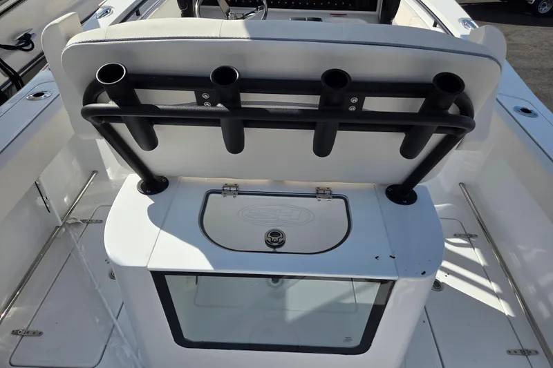 Slide: The Image of 2026 Sea Hunt Gamefish 25 boat interior with rod holders and storage compartment. - 8