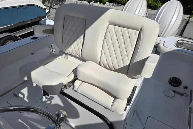 Slide: The Image of 2026 Sea Hunt Gamefish 25 boat seat with white upholstery and diamond stitching. - 9