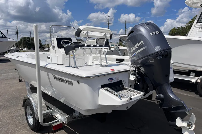 Slide: The Image of 2026 Tidewater 1910 Bay Max boat with Yamaha 115 engine on trailer, under blue sky. - 2
