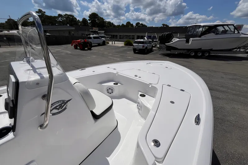 Slide: The Image of 2026 Tidewater 1910 Bay Max boat, white interior, parked outdoors under a cloudy sky. - 8