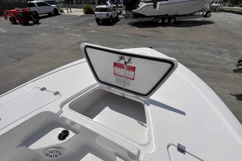 Slide: The Image of Open storage compartment on 2026 Tidewater 1910 Bay Max boat, parked outdoors. - 9