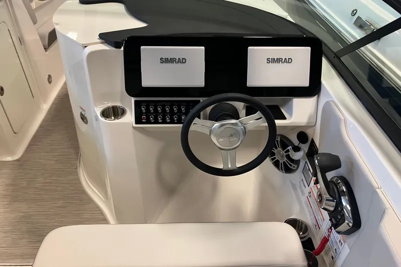 Slide: The Image of 2025 Sea Ray SDX 270 helm with dual Simrad displays and modern controls. - 10