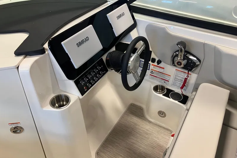 Slide: The Image of 2025 Sea Ray SDX 270 helm with Simrad displays and modern controls. - 11