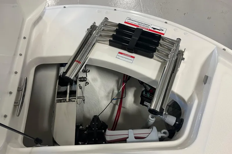 Slide: The Image of 2025 Sea Ray SDX 270 boat compartment with stainless steel ladder and mechanical components. - 14