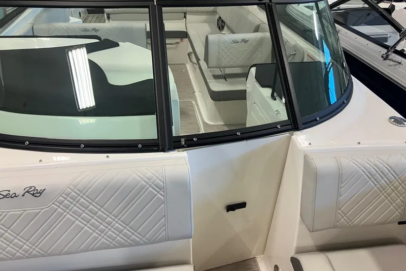 Slide: The Image of 2025 Sea Ray SDX 270 boat interior with white seating and windshield. - 16