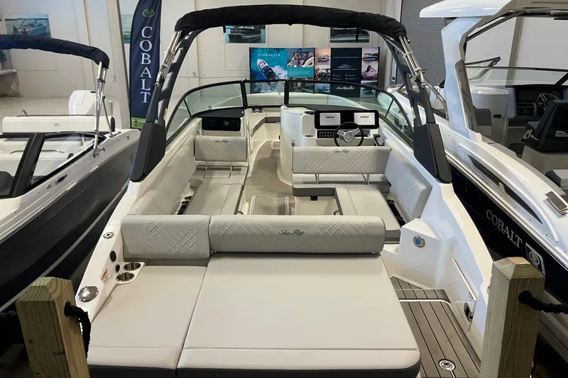 Slide: The Image of 2025 Sea Ray SDX 270 boat interior with luxurious seating and modern dashboard. - 2