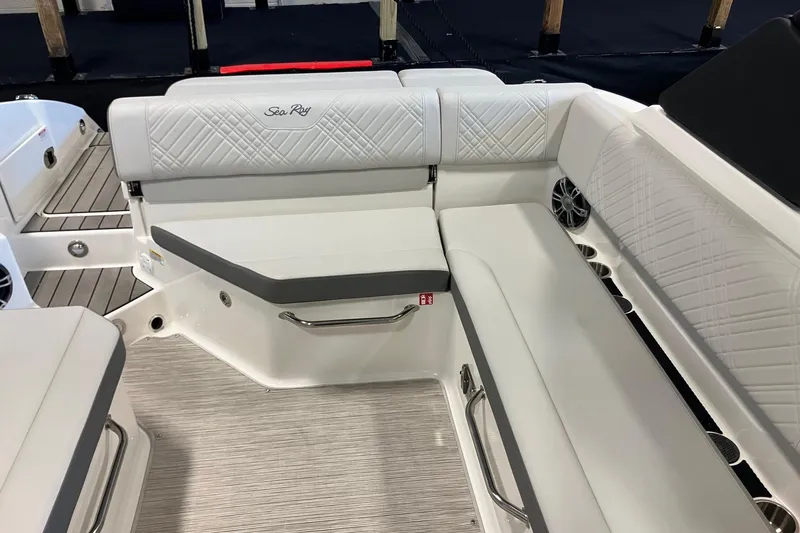 Slide: The Image of 2025 Sea Ray SDX 270 boat interior with white cushioned seating and sleek design. - 5