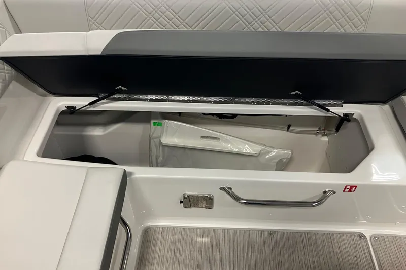 Slide: The Image of Open storage compartment on 2025 Sea Ray SDX 270 boat, featuring sleek interior design. - 7