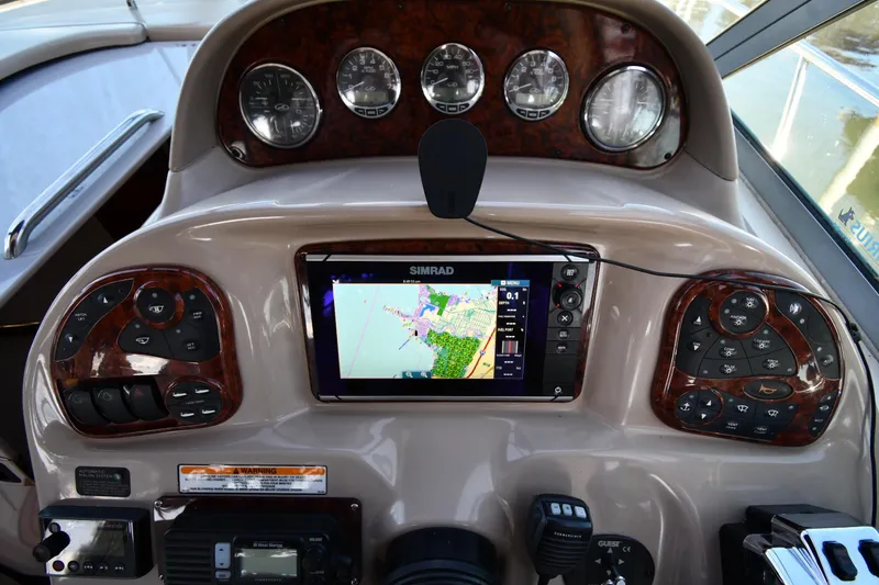 Slide: The Image of Dashboard of a 2005 Sea Ray 300 Sundancer with navigation system and controls. - 12
