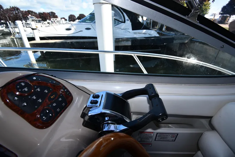 Slide: The Image of 2005 Sea Ray 300 Sundancer helm with controls and view of marina. - 14