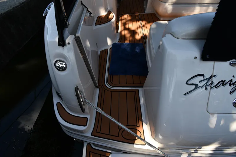 Slide: The Image of 2005 Sea Ray 300 Sundancer boat deck with wood finish and blue mat. - 22