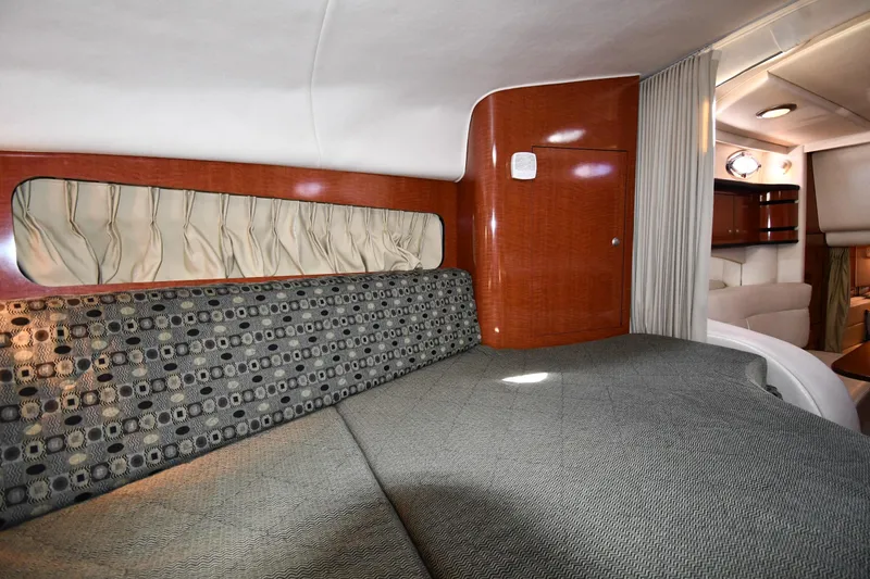 Slide: The Image of 2005 Sea Ray 300 Sundancer cabin interior with elegant wood finish and comfortable seating. - 29