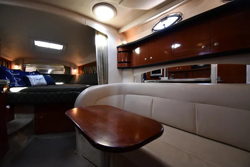 Slide: The Image of Interior of 2005 Sea Ray 300 Sundancer yacht with cozy seating and elegant wood finishes. - 30