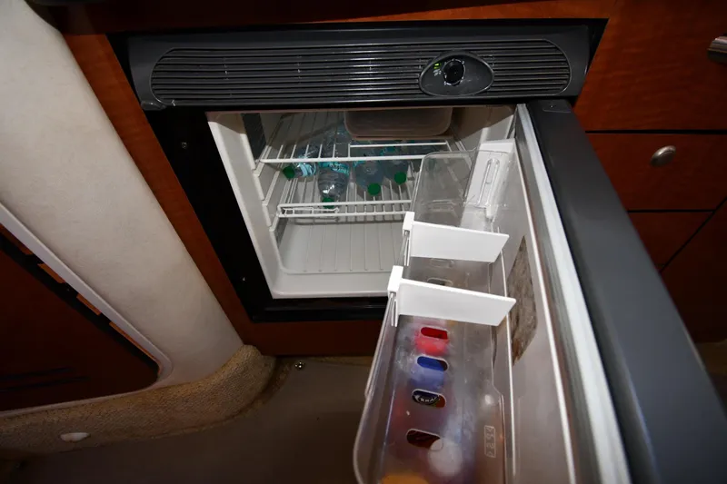 Slide: The Image of Mini fridge inside 2005 Sea Ray 300 Sundancer yacht, stocked with beverages. - 38