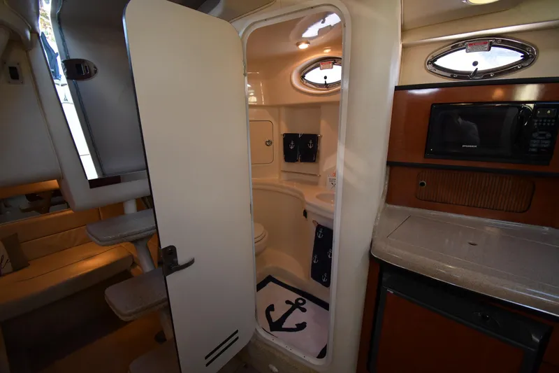 Slide: The Image of Interior of 2005 Sea Ray 300 Sundancer with kitchenette and bathroom. - 39
