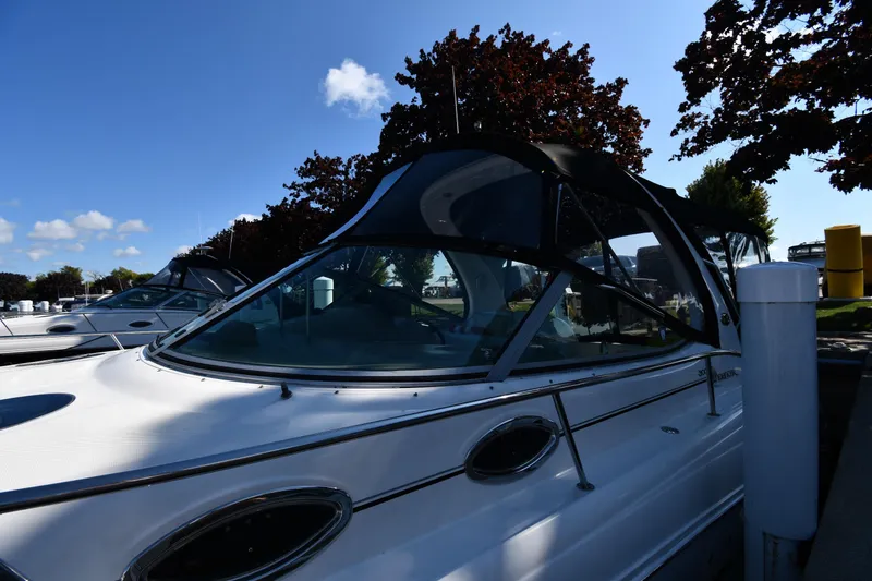 Slide: The Image of 2005 Sea Ray 300 Sundancer docked under clear blue sky. - 4