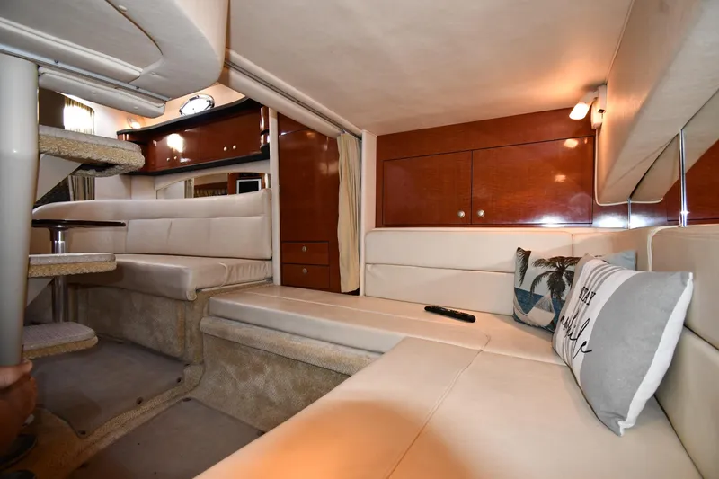 Slide: The Image of Interior of 2005 Sea Ray 300 Sundancer yacht with plush seating and elegant wood finishes. - 42