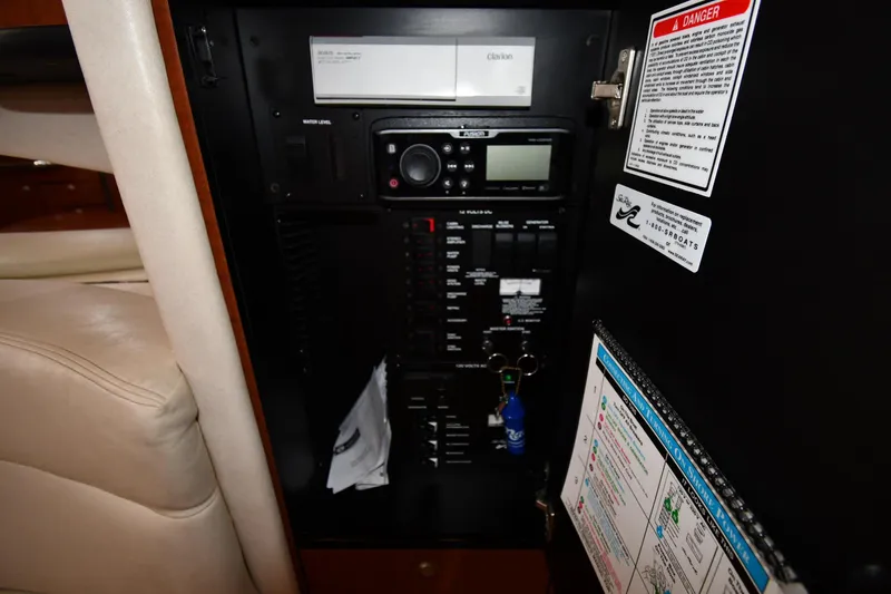 Slide: The Image of Control panel inside a 2005 Sea Ray 300 Sundancer boat, featuring various switches and labels. - 45