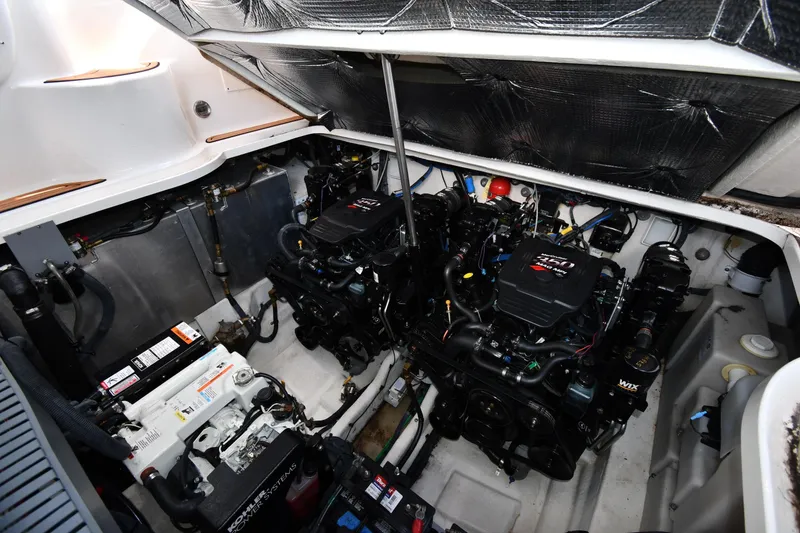 Slide: The Image of Engine compartment of a 2005 Sea Ray 300 Sundancer boat, showcasing dual engines. - 47