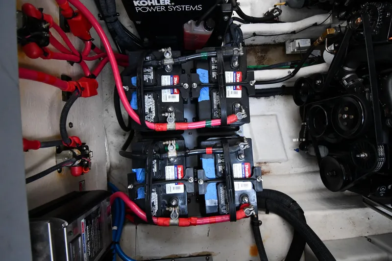Slide: The Image of Engine compartment of a 2005 Sea Ray 300 Sundancer with batteries and wiring. - 49