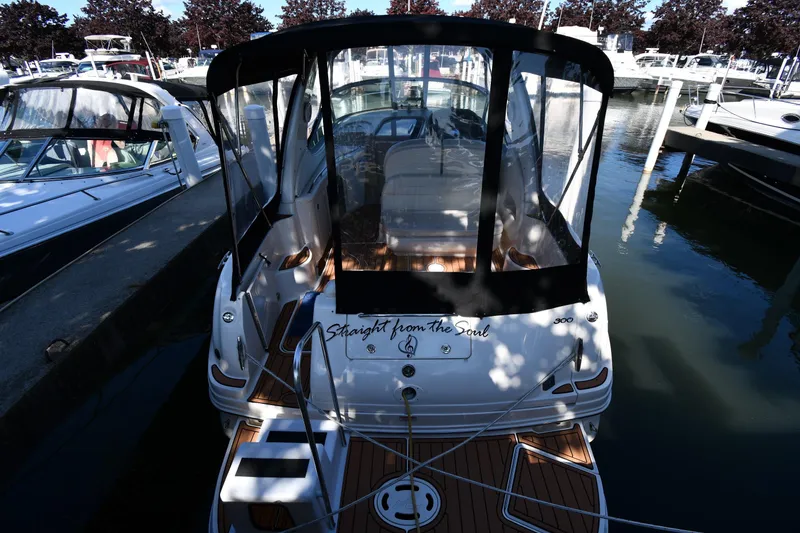 Slide: The Image of 2005 Sea Ray 300 Sundancer docked at marina, rear view with canopy. - 8