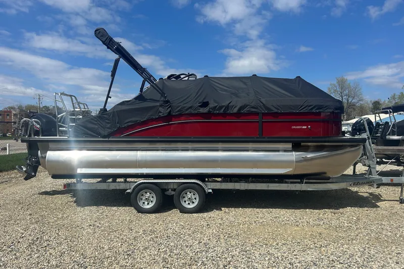 The Image of 2026 Harris FloteBote Cruiser 210 SL pontoon boat on trailer, covered, outdoors. - 0