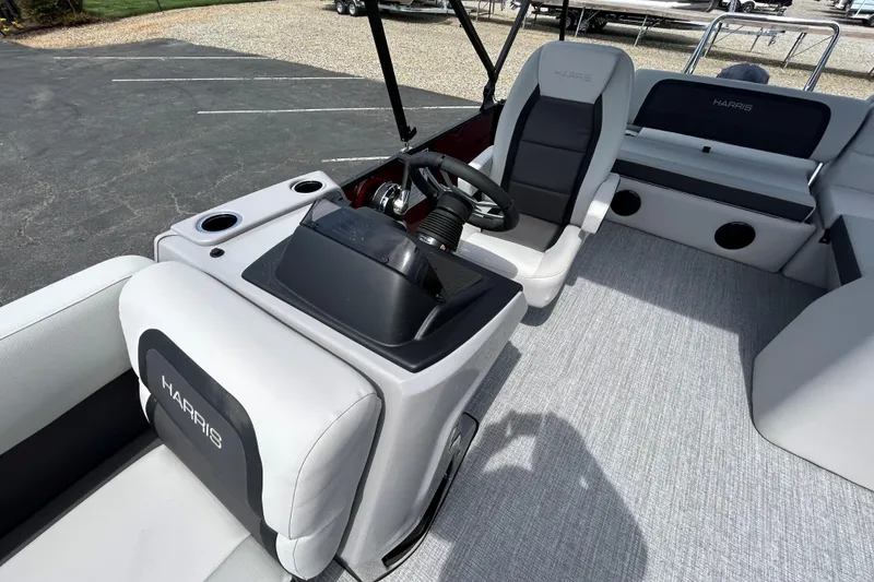 Slide: The Image of 2026 Harris FloteBote Cruiser 210 SL interior with modern seating and steering console. - 12