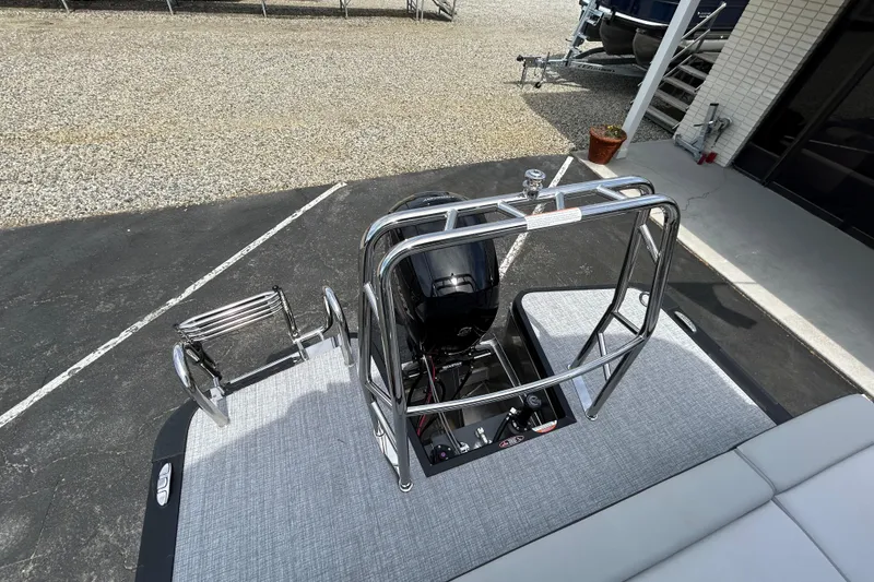 Slide: The Image of 2026 Harris FloteBote Cruiser 210 SL pontoon boat with sleek metal railing and motor. - 16