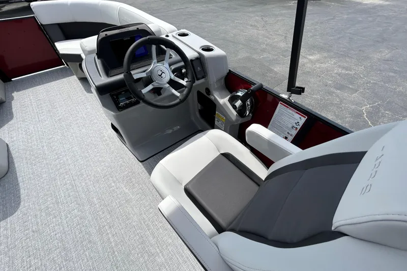 Slide: The Image of Interior view of 2026 Harris FloteBote Cruiser 210 SL boat cockpit with modern steering and seating. - 17