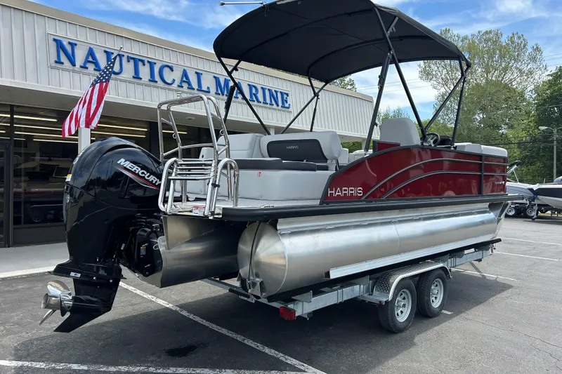 Slide: The Image of 2026 Harris FloteBote Cruiser 210 SL pontoon boat at dealership, featuring Mercury outboard motor. - 6