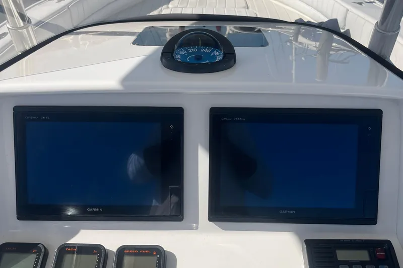 Slide: The Image of Dashboard of a 2004 Intrepid 323 boat with Garmin GPS displays and compass. - 10