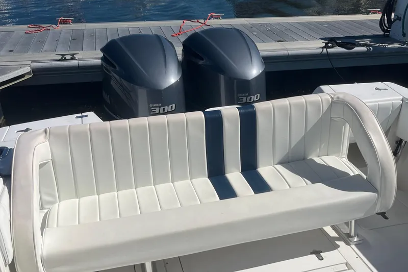 Slide: The Image of 2004 Intrepid 323 boat with Yamaha 300 engines and white cushioned seating. - 14