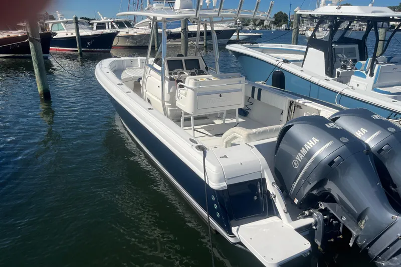 Slide: The Image of 2004 Intrepid 323 boat with Yamaha engines docked in a marina. - 2