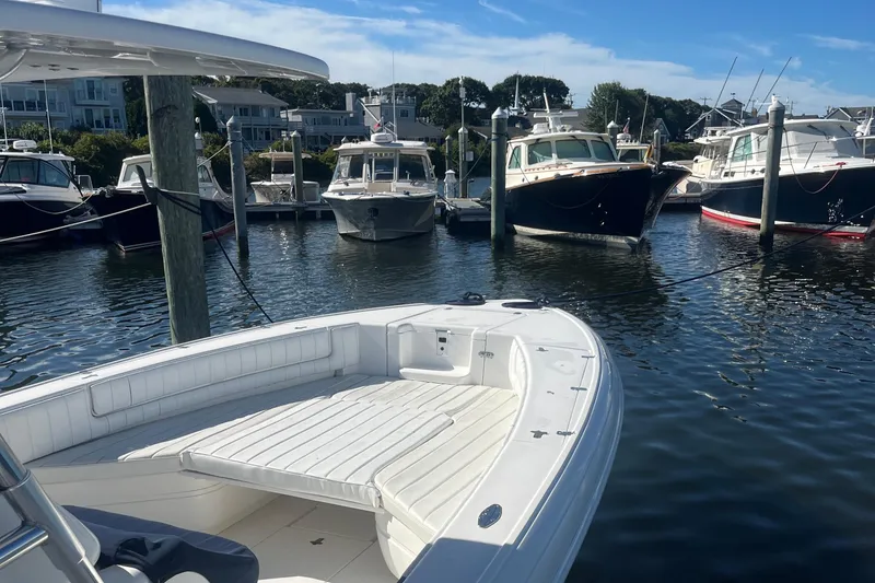 Slide: The Image of 2004 Intrepid 323 boat docked in a marina with other vessels. - 3