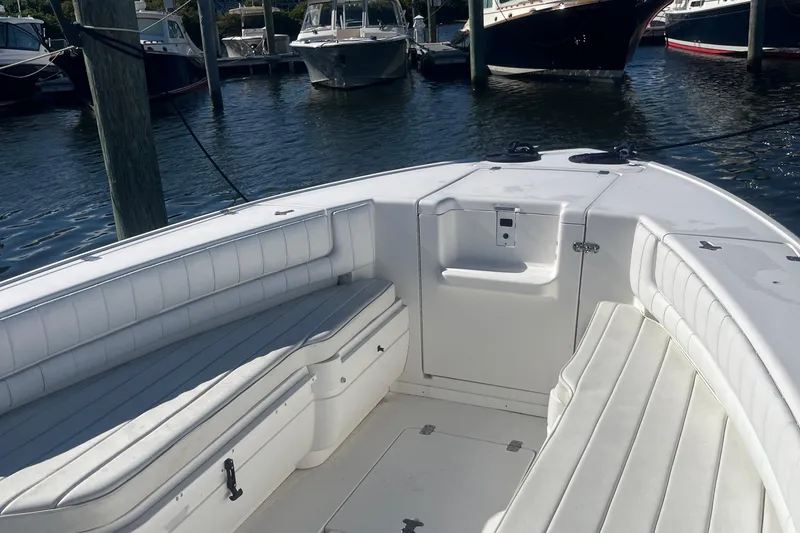 Slide: The Image of 2004 Intrepid 323 boat interior with white seating, docked in a marina. - 5
