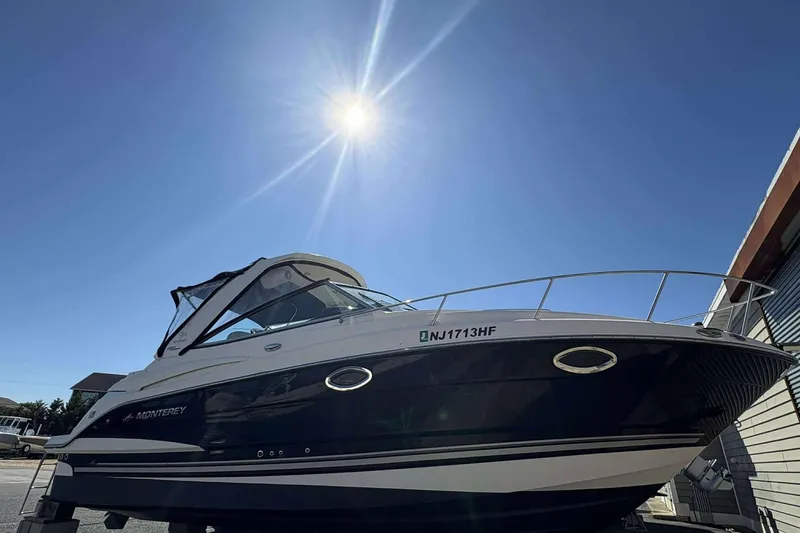 The Image of 2013 Monterey 260 SCR Sport Cruiser under bright sun, docked outdoors. - 1