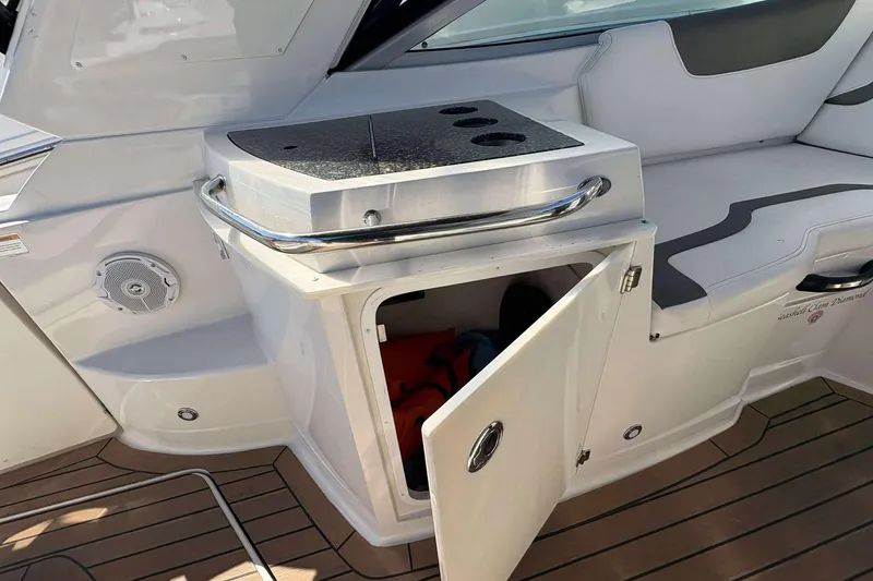 Slide: The Image of 2013 Monterey 260 SCR Sport Cruiser interior with open storage compartment and seating. - 13