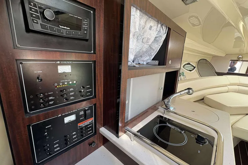 Slide: The Image of Interior of 2013 Monterey 260 SCR Sport Cruiser with control panel and kitchenette. - 19