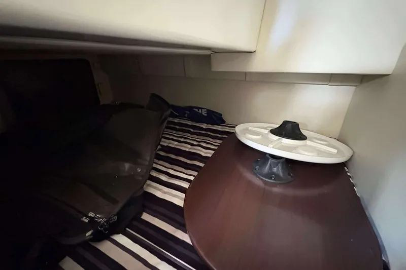Slide: The Image of Interior cabin of 2013 Monterey 260 SCR Sport Cruiser with striped bedding and table. - 20