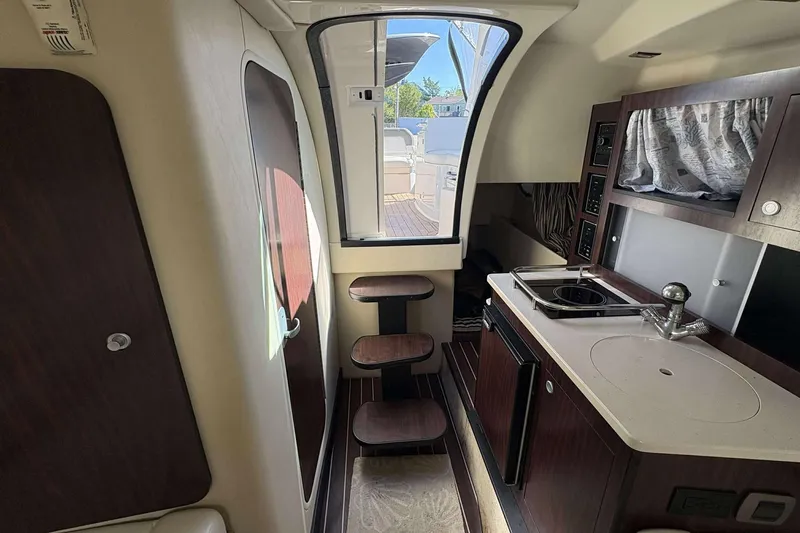 Slide: The Image of Interior of 2013 Monterey 260 SCR Sport Cruiser with kitchenette and steps to deck. - 21