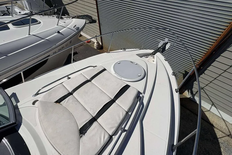 Slide: The Image of 2013 Monterey 260 SCR Sport Cruiser boat deck with sunpad and railing. - 5