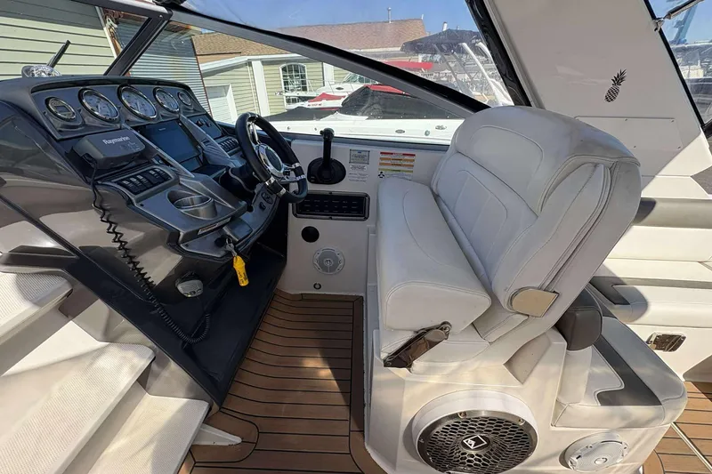 Slide: The Image of Cockpit of 2013 Monterey 260 SCR Sport Cruiser with modern controls and white seating. - 6