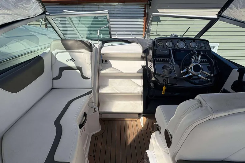 Slide: The Image of 2013 Monterey 260 SCR Sport Cruiser interior with helm, seating, and dashboard controls. - 7