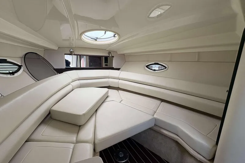 Slide: The Image of Luxurious interior of 2013 Monterey 260 SCR Sport Cruiser with plush seating and porthole windows. - 9