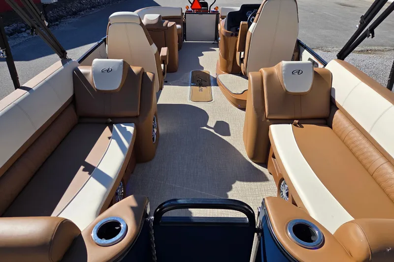 Slide: The Image of 2023 Avalon Platinum 2385 Catalina Quad Lounger interior with luxurious seating and cup holders. - 12