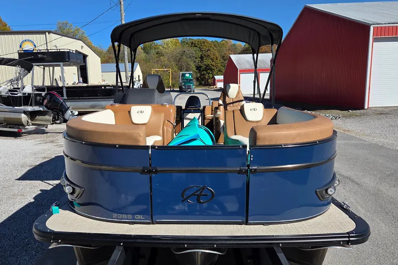 Slide: The Image of 2023 Avalon Platinum 2385 Catalina Quad Lounger pontoon boat in a marina setting. - 3