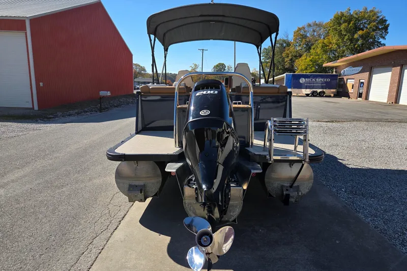 Slide: The Image of 2023 Avalon Platinum 2385 Catalina Quad Lounger pontoon boat with outboard motor, parked outdoors. - 4
